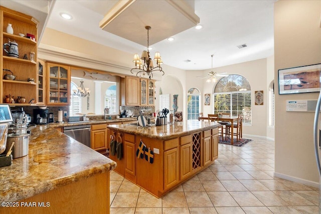 kitchen with a sink, light tile patterned floors, visible vents, and dishwasher