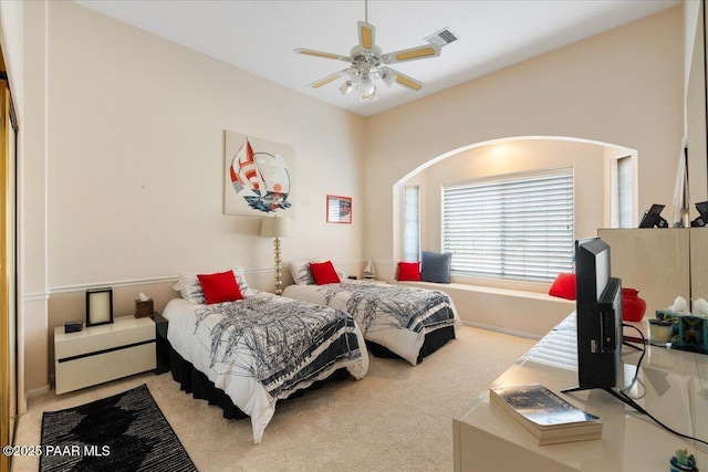 carpeted bedroom featuring ceiling fan and visible vents