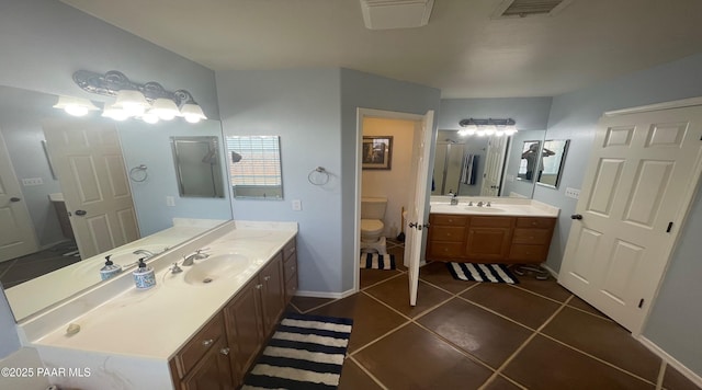 bathroom featuring tile patterned floors, vanity, and toilet