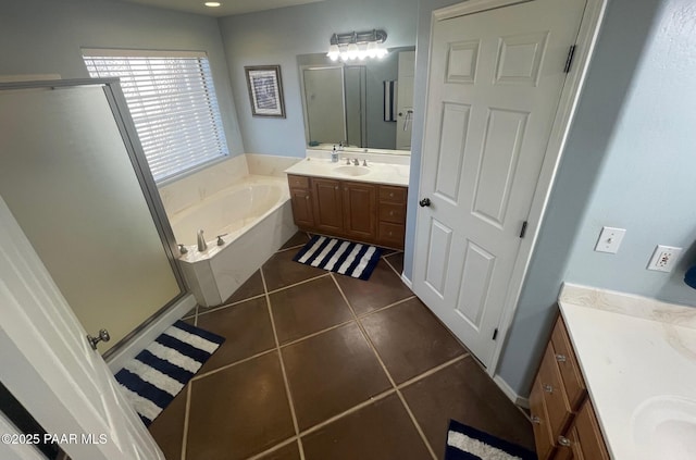 bathroom featuring tile patterned floors, plus walk in shower, and vanity