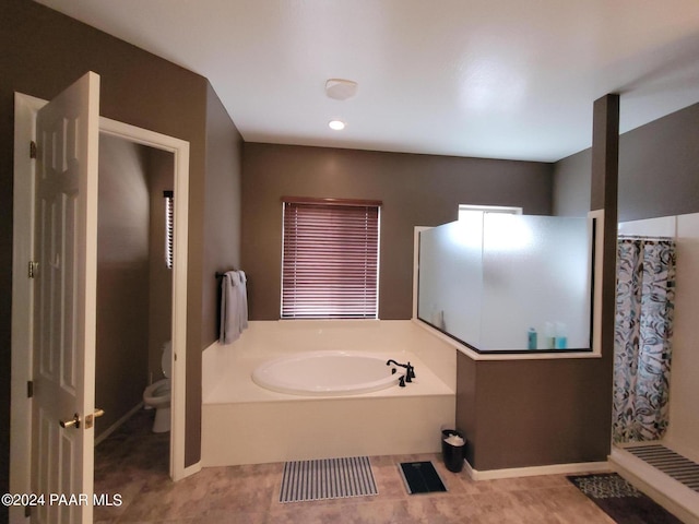 bathroom with plus walk in shower, tile patterned floors, and toilet