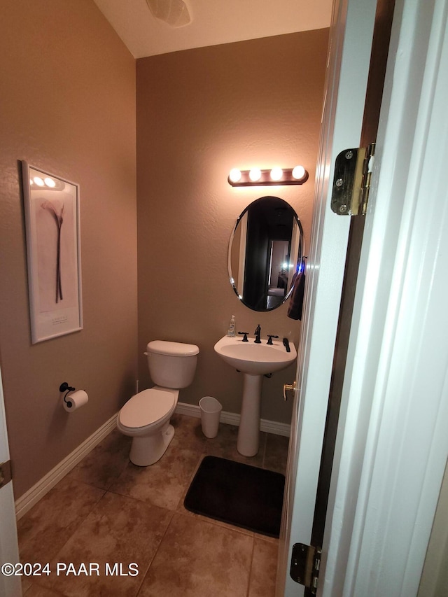 bathroom with tile patterned flooring and toilet