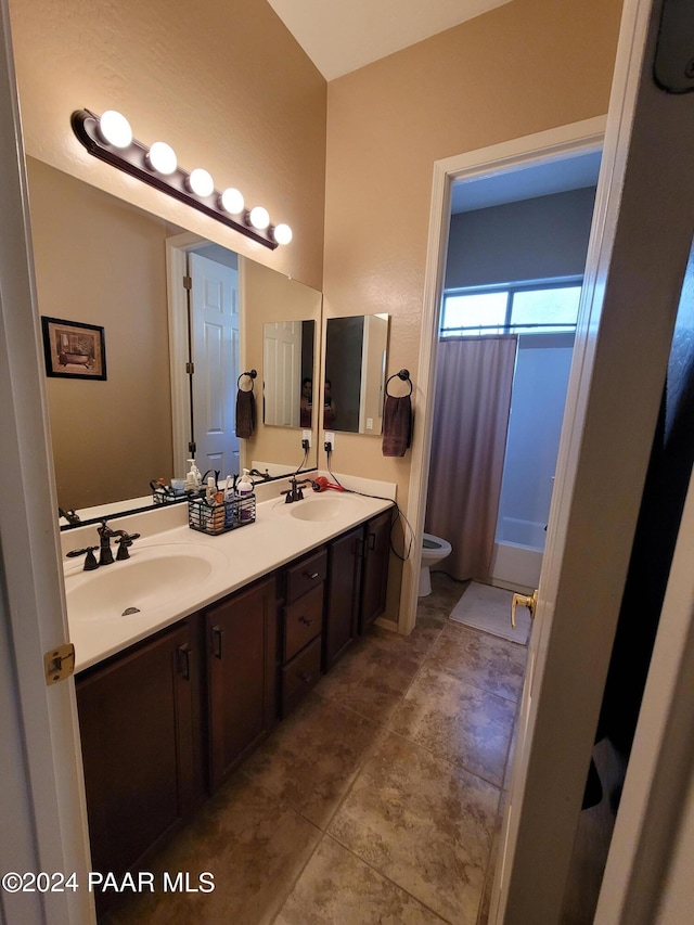 bathroom with tile patterned floors, vanity, and toilet