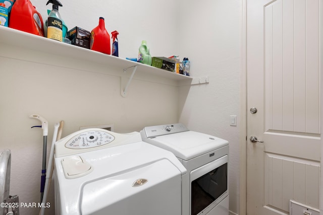washroom featuring washing machine and clothes dryer and laundry area