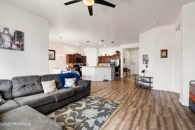 living room with wood finished floors and a ceiling fan