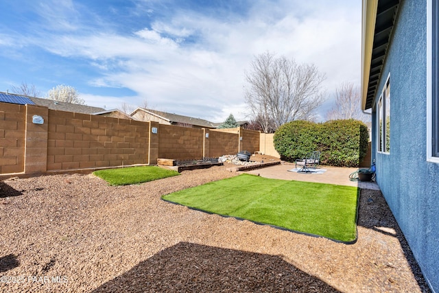 view of yard with a fenced backyard and a patio area