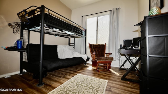 bedroom with wood finished floors and baseboards