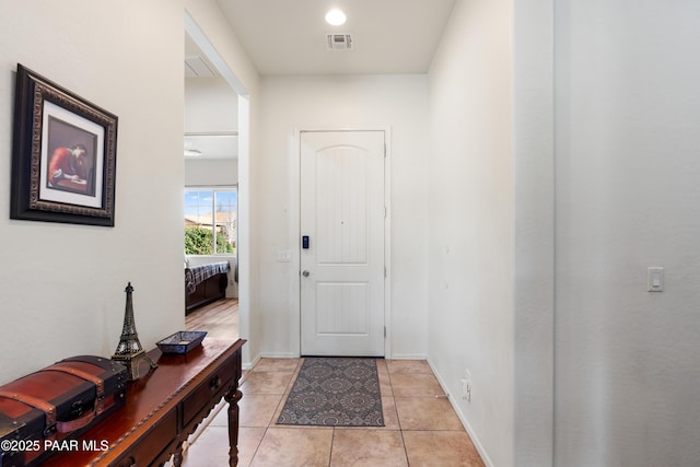 entryway with light tile patterned flooring, visible vents, and baseboards