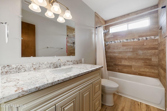 full bathroom with shower / bath combination with curtain, vanity, hardwood / wood-style flooring, and toilet