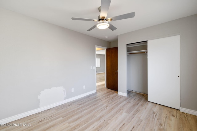 unfurnished bedroom featuring ceiling fan, light hardwood / wood-style flooring, and a closet