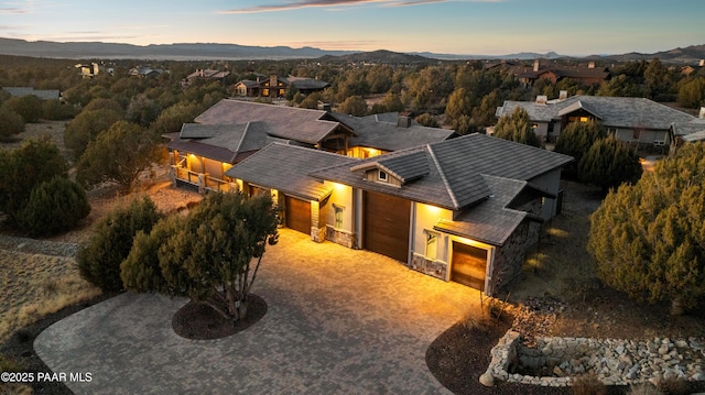 aerial view at dusk featuring a mountain view