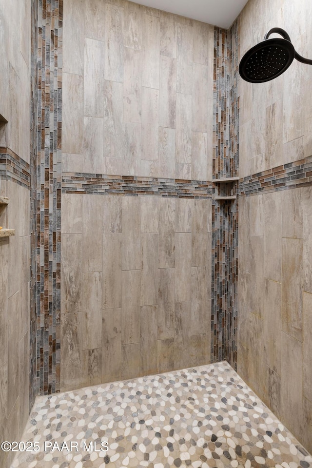 bathroom with tiled shower