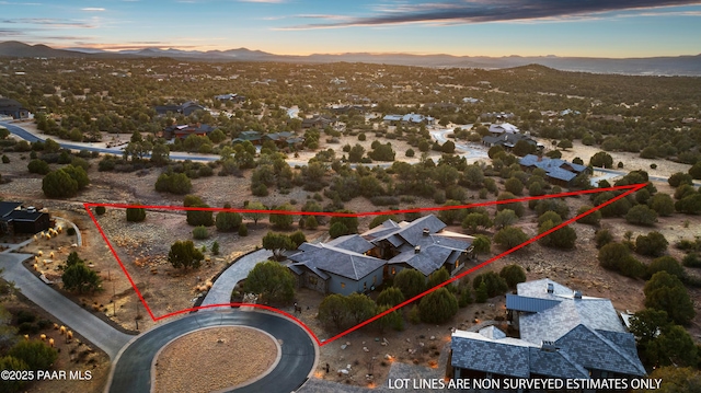 aerial view at dusk featuring a mountain view