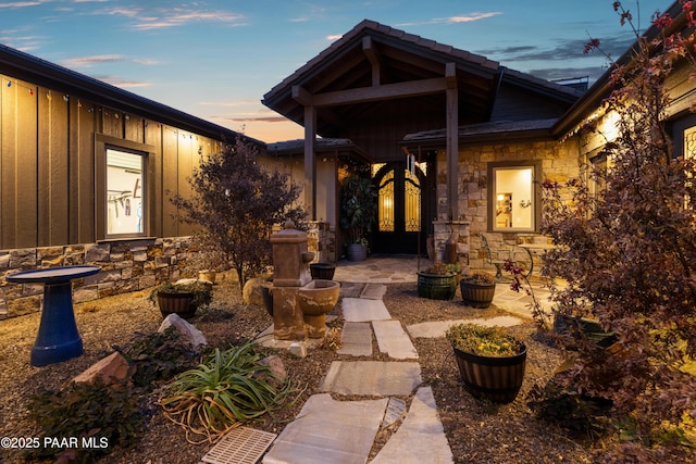 exterior entry at dusk with a patio area