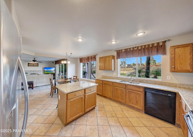 kitchen with decorative light fixtures, light tile patterned floors, stainless steel fridge, black dishwasher, and a kitchen island