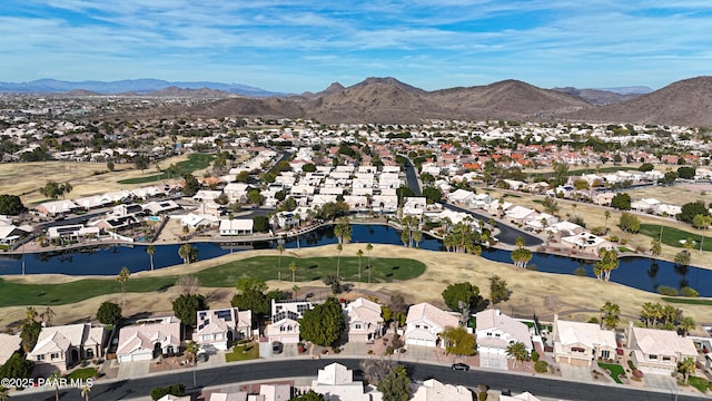 birds eye view of property with a water and mountain view