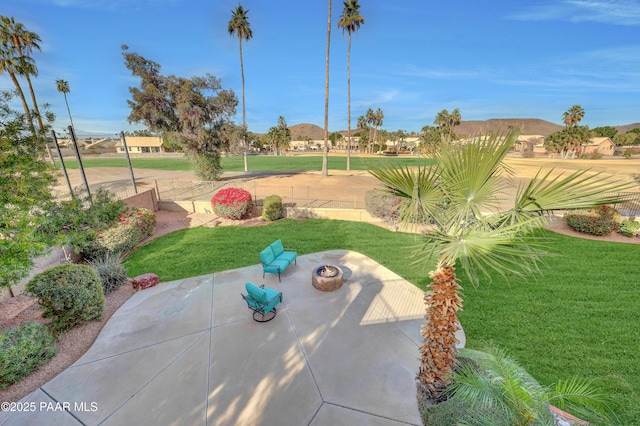 exterior space with an outdoor fire pit, a patio area, and a lawn