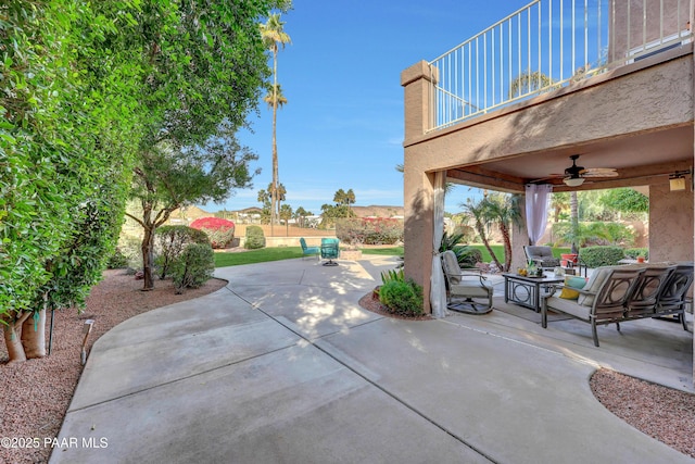 view of patio / terrace featuring ceiling fan, an outdoor living space, and a balcony