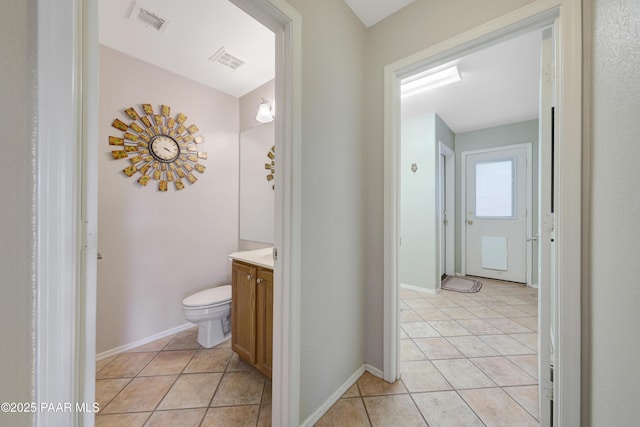 bathroom with vanity, tile patterned floors, and toilet