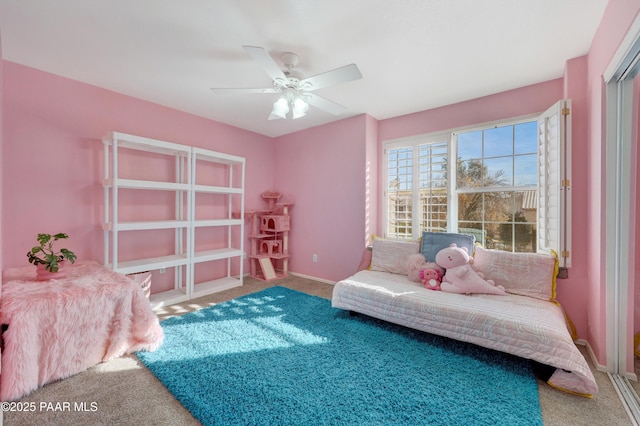 living area featuring carpet floors and ceiling fan