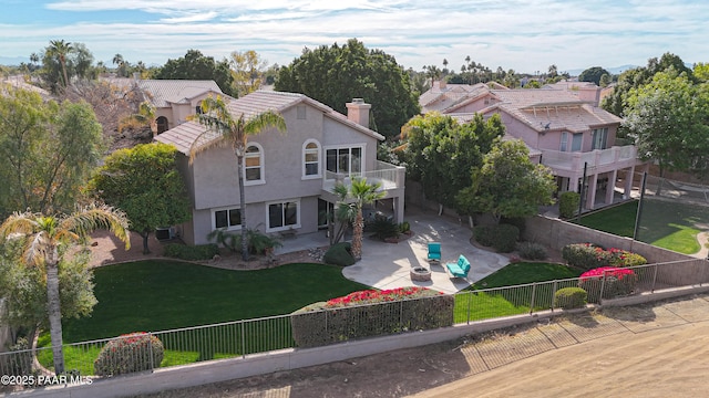 view of front of home featuring a balcony and a patio area