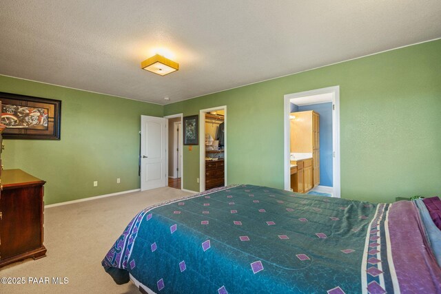 9341 E Manzanita Cir, Prescott Valley, AZ 86314 - bedroom featuring carpet flooring, connected bathroom, a walk in closet, baseboards, and a closet