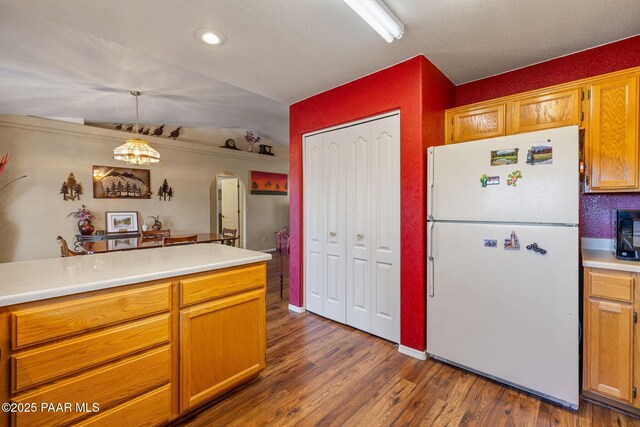9341 E Manzanita Cir, Prescott Valley, AZ 86314 - kitchen featuring freestanding refrigerator, dark wood-style flooring, light countertops, arched walkways, and vaulted ceiling