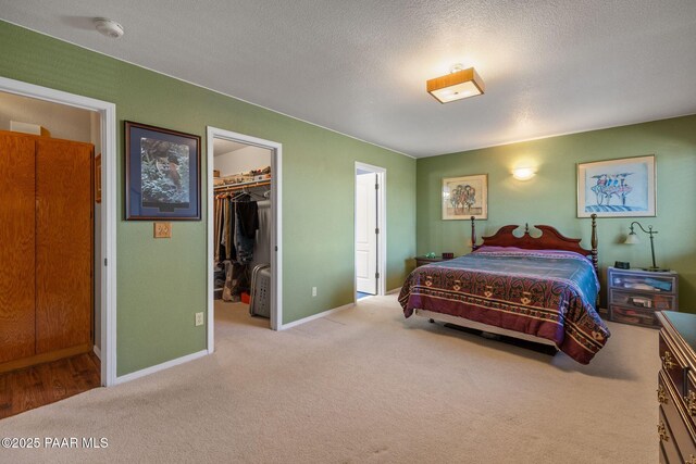 9341 E Manzanita Cir, Prescott Valley, AZ 86314 - carpeted bedroom featuring baseboards, a textured ceiling, a spacious closet, and a closet