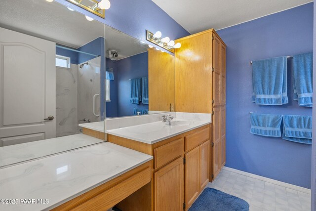 9341 E Manzanita Cir, Prescott Valley, AZ 86314 - bathroom featuring vanity, baseboards, walk in shower, and tile patterned floors