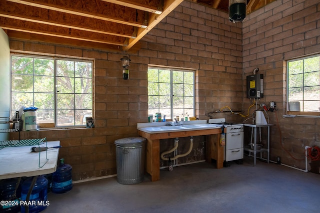 misc room with water heater and a healthy amount of sunlight