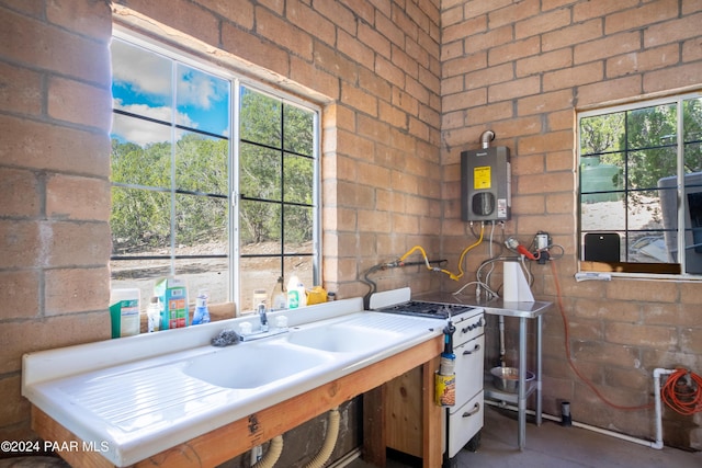 kitchen featuring water heater and concrete flooring