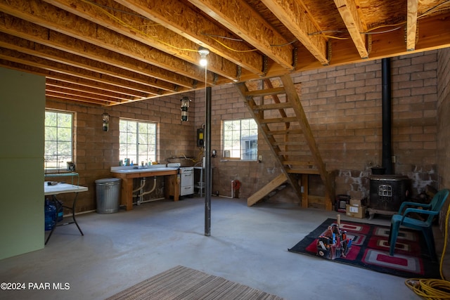 interior space featuring a wood stove and concrete flooring