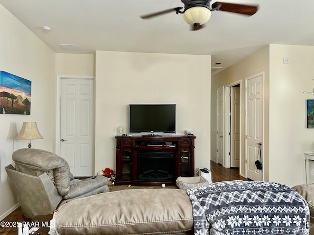 living room with ceiling fan and dark wood-type flooring