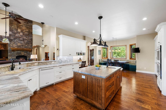 2469 W Post Oak Dr, Prescott, AZ 86305 - kitchen featuring a stone fireplace, white appliances, ceiling fan, light stone countertops, and recessed lighting