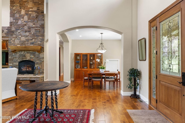 2469 W Post Oak Dr, Prescott, AZ 86305 - foyer entrance with a towering ceiling, hardwood / wood-style floors, arched walkways, and a fireplace
