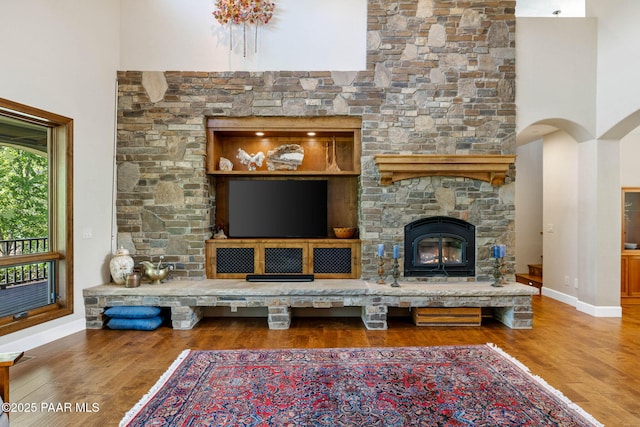 2469 W Post Oak Dr, Prescott, AZ 86305 - living room featuring wood finished floors, a fireplace, and a towering ceiling