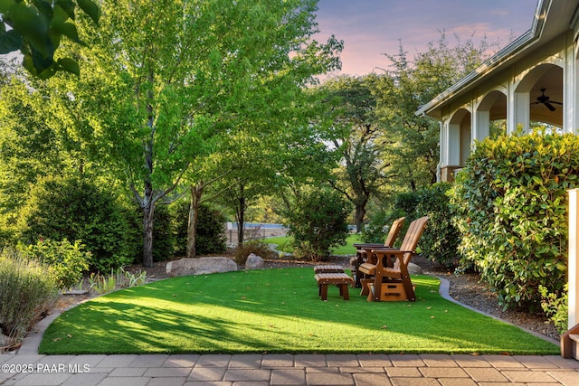2469 W Post Oak Dr, Prescott, AZ 86305 - yard at dusk featuring a yard and ceiling fan