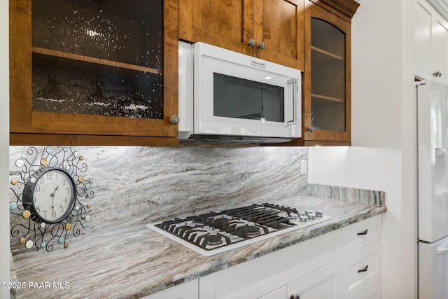 2469 W Post Oak Dr, Prescott, AZ 86305 - kitchen featuring white appliances, glass insert cabinets, white cabinetry, and light stone countertops