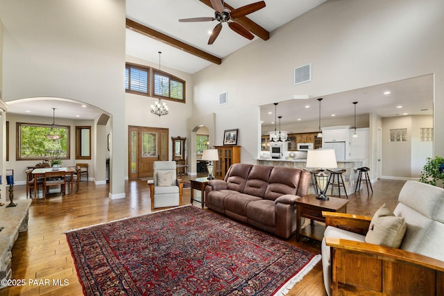2469 W Post Oak Dr, Prescott, AZ 86305 - living room with arched walkways, high vaulted ceiling, ceiling fan, light wood-type flooring, and beam ceiling