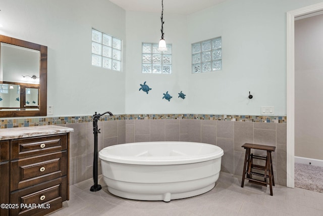 2469 W Post Oak Dr, Prescott, AZ 86305 - full bath featuring tile walls, a soaking tub, tile patterned flooring, vanity, and wainscoting