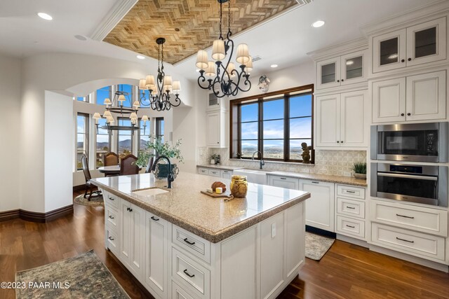 kitchen featuring dark hardwood / wood-style flooring, stainless steel appliances, white cabinetry, and sink