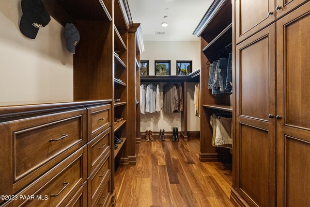 spacious closet featuring dark hardwood / wood-style floors