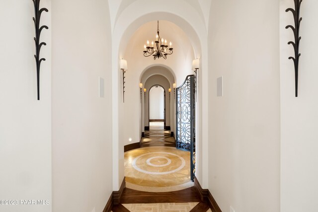 hall featuring an inviting chandelier