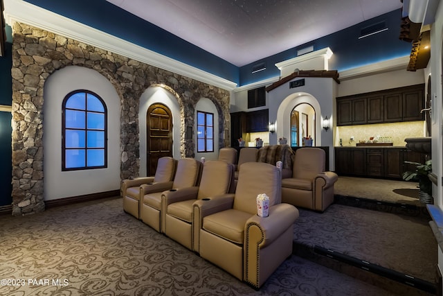 home theater room with a towering ceiling