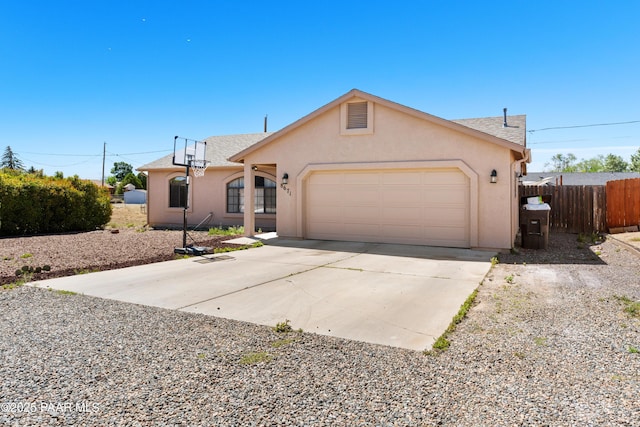 8671 E Apache Dr, Prescott Valley, AZ 86314 - view of front facade with a garage, stucco siding, and concrete driveway