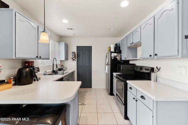 8671 E Apache Dr, Prescott Valley, AZ 86314 - kitchen with stainless steel appliances, light countertops, recessed lighting, pendant lighting, and a peninsula