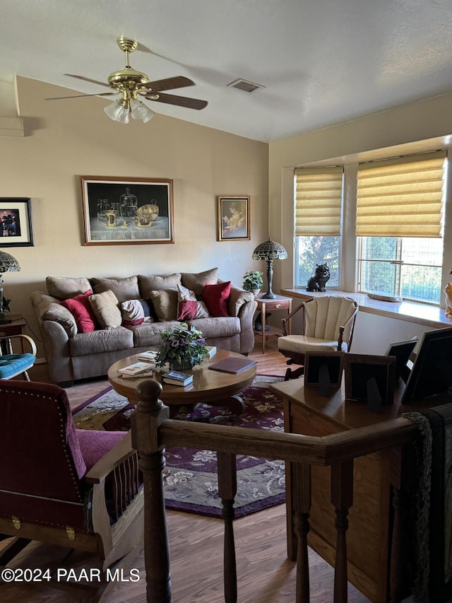 living room with wood-type flooring and ceiling fan