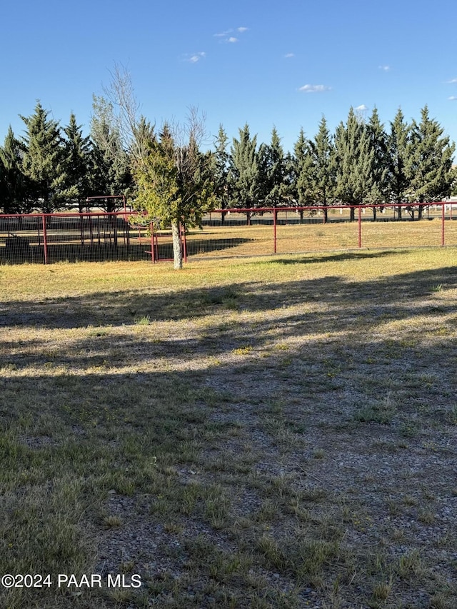 view of home's community with a yard and a rural view