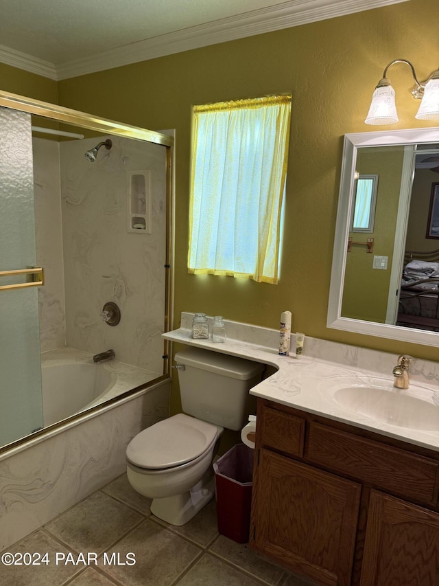 full bathroom with tile patterned floors, vanity, crown molding, shower / bath combination with glass door, and toilet