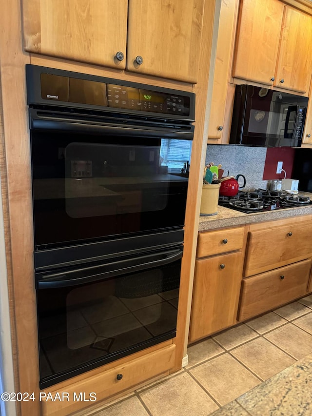 kitchen with light tile patterned floors and black appliances